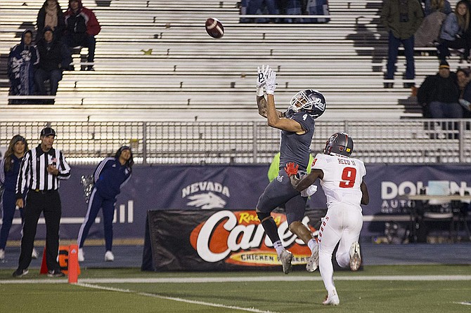 Nevada wide receiver Elijah Cooks catches a touchdown over New Mexico&#039;s Jerrick Reed II in the fourth quarter Saturday.
