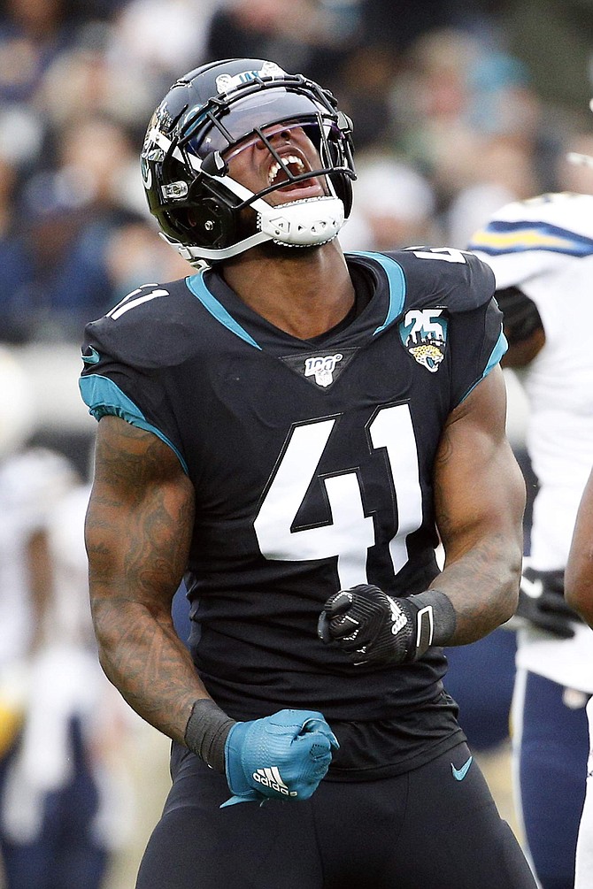 Jacksonville Jaguars defensive end Josh Allen (41) celebrates after he and teammates sacked Los Angeles Chargers quarterback Philip Rivers during the first half of an NFL football game, Sunday, Dec. 8, 2019, in Jacksonville, Fla. (AP Photo/Stephen B. Morton)