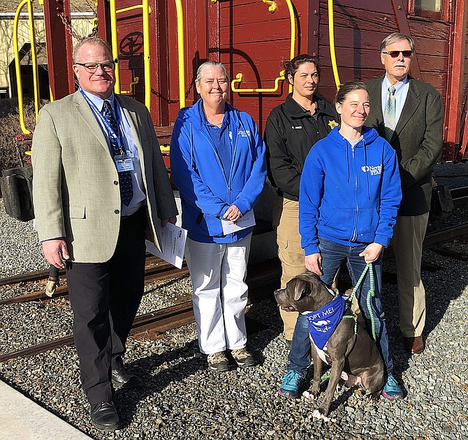 Nevada State Museum director Dan Thielen, left, is joined by volunteers from the Nevada Humane Society and the National Rifle Association after receiving monetary gifts for their respective organizations given in memory of longtime Carson City resident Frances M. Parker.