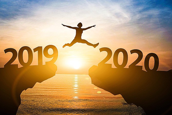 Man jump from year 2019 to 2020. Starting of new year concept.
