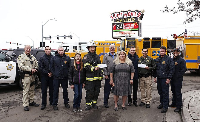 Carson City Sheriff and Fire officials pose with SlotWorld representatives on Dec. 4. Following the third annual Feast with a Hero event, SlotWorld donated $15,000 to the Holiday with a Hero program.