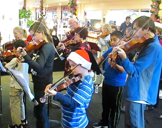 String instrument players of all ages at a previous Christmas Carol Playalong.