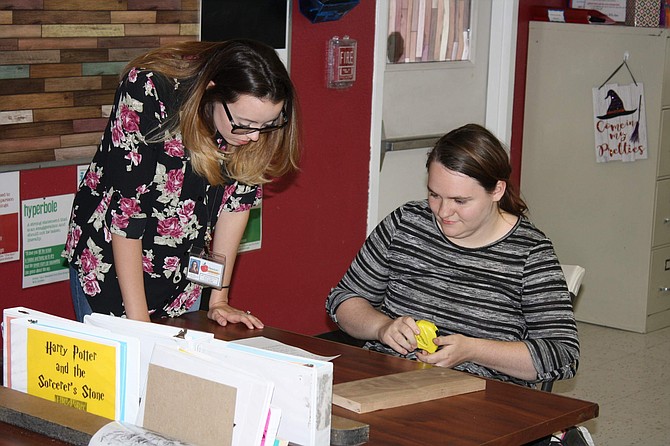 Katy Nickles, lead special education teacher works with student Brianna Ward at Newton Learning Center, which is presenting the Wrightslaw Conference to empower parents toward success in the IEP process on Thursday, Dec. 5.