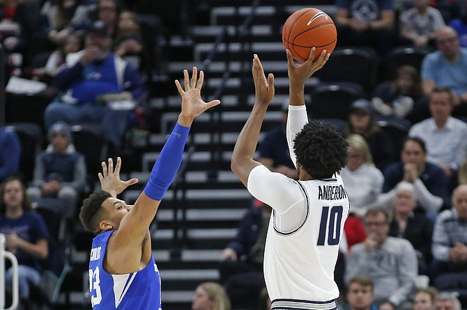 Utah State forward Alphonso Anderson (10) shoots as BYU forward Yoeli Childs (23) defends in the first half during an NCAA college basketball game Saturday, Dec. 14, 2019, in Salt Lake City. (AP Photo/Rick Bowmer)