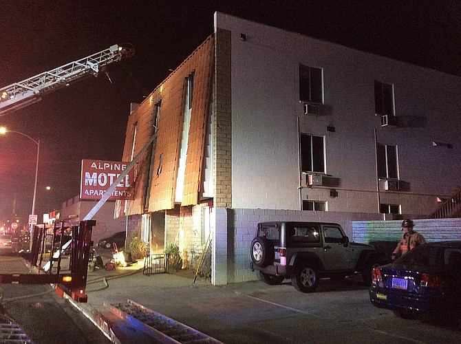 This photo provided by the Las Vegas Fire Department, firefighters work the scene of a fire at a three-story apartment complex early Saturday, Dec. 21, 2019 in Las Vegas.  The fire was in first-floor unit of the Alpine Motel Apartments and its cause was under investigation, the department said.  Authorities say multiple fatalities were reported and several were injured.   (Las Vegas Fire Department via AP)