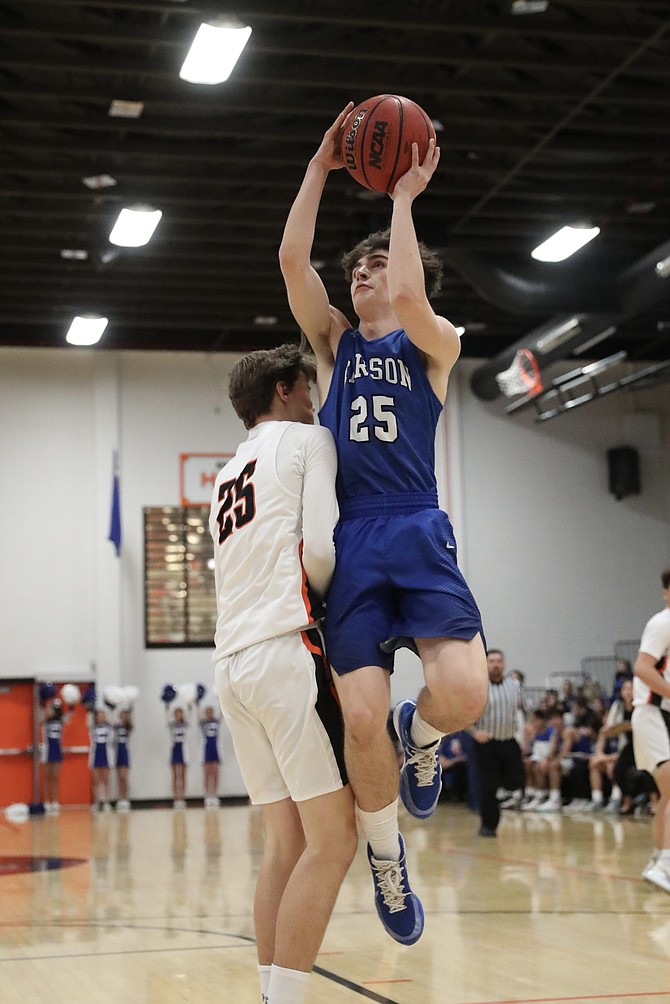 Carson High&#039;s Gage Mills goes up for a shot Tuesday night against Douglas. 
