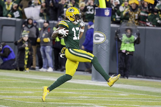Green Bay Packers&#039; Davante Adams runs to the endzone for his touchdown catch during the second half of an NFL divisional playoff football game against the Seattle Seahawks Sunday, Jan. 12, 2020, in Green Bay, Wis. (AP Photo/Darron Cummings)