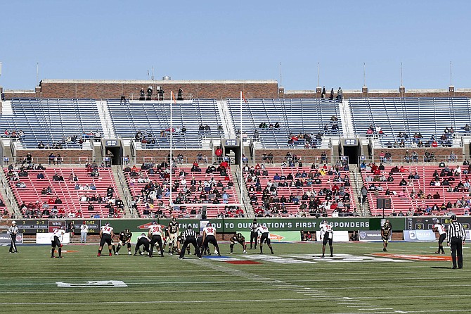 FILE- This Dec. 30, 2019, file photo shows empty seats as Western Kentucky and Western Michigan line up for the snap during the second half of the NCAA First Responder Bowl college football game in Dallas. Bowls outside the College Football Playoff structure might excite only the most ardent fans of the participating teams, be played in half-empty stadiums and prompt howls about there being too many games. They aren&#039;t going away, though. There&#039;ll be three more next season, bringing the total number of bowls to 42. (AP Photo/Roger Steinman, File)