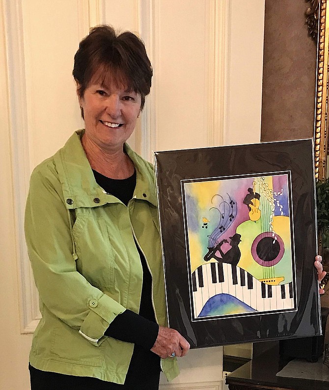Artist Reta Hanks shows her winning painting, used for the cover of the Jazz &#038; Beyond program and the festival T-shirt last year.