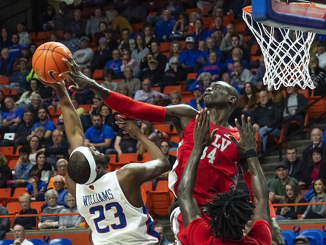 UNLV forward Cheikh Mbacke Diong blocks a shot by Boise State guard RJ Williams but is called for a foul during an NCAA college basketball game Wednesday, Jan. 8, 2020, in Boise, Idaho. (Darin Oswald/Idaho Statesman via AP)