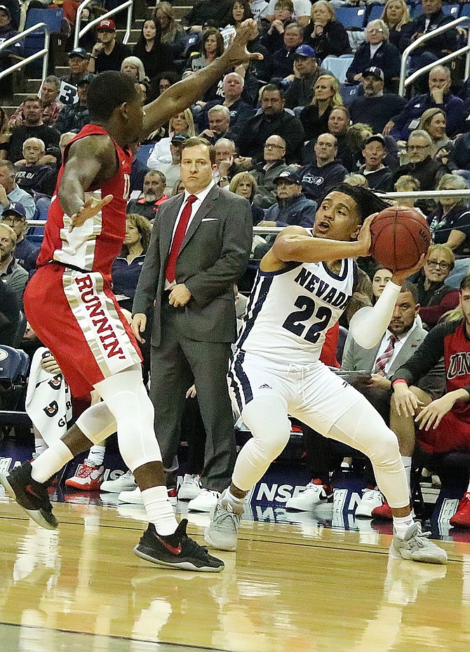 UNLV&#039;s Amauri Hardy guards Nevada&#039;s Jazz Johnson the corner by the Rebels bench in Wednesday&#039;s Mountain West Conference game.