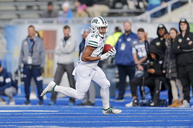 Ohio running back De&#039;Montre Tuggle (24) runs the ball against Nevade in the first half of the Famous Idaho Potato Bowl NCAA college football game Friday, Jan. 3, 2020, in Boise, Idaho. (AP Photo/Steve Conner)