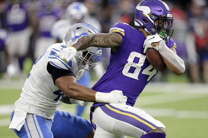 Minnesota Vikings tight end Irv Smith tries to break a tackle by Detroit Lions outside linebacker Devon Kennard, left, after catching a pass during the second half of an NFL football game, Sunday, Dec. 8, 2019, in Minneapolis. (AP Photo/Andy Clayton-King)