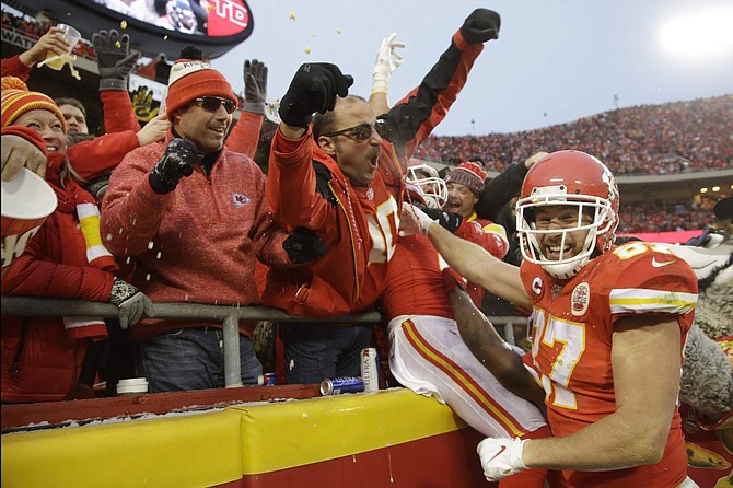 Kansas City Chiefs tight end Travis Kelce (87) celebrates with fans after tight end Blake Bell scored a touchdown against the Houston Texans, during the second half of an NFL divisional playoff football game, in Kansas City, Mo., Sunday, Jan. 12, 2020. (AP Photo/Charlie Riedel)