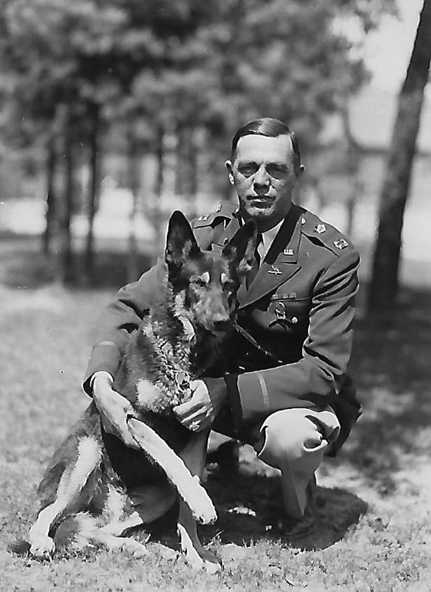 Captain Whittlemore and his dog. My dad wrote on the back, &quot;Captain Whittlemore, a good egg.&quot; Capt. Whittlemore was a firm, but fair camp commander.