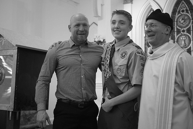 From left, Grant Denton, Preston Emborsky and Fr. Jeff Paul unveil Emborsky&#039;s Karma Box as part of his Eagle Scout project at St. Peter&#039;s Episcopal Church at 314 N. Division St.