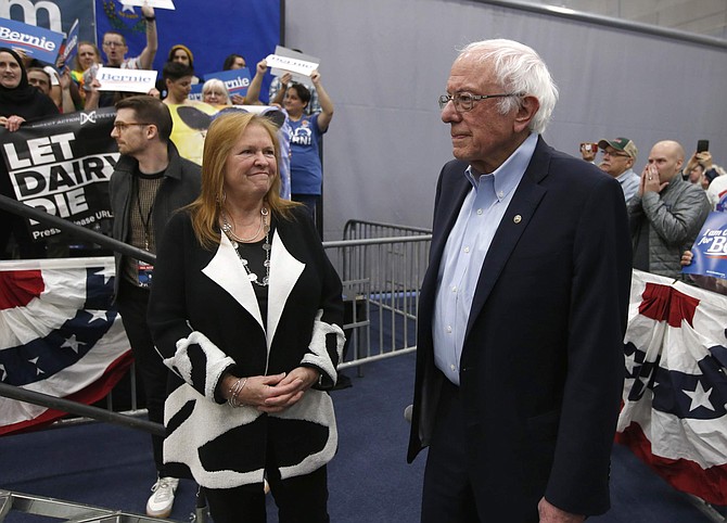 Democratic presidential candidate Sen. Bernie Sanders I-Vt., waits, with his wife Jane, left, as protestors who interrupted his campaign event were removed from the stage, in Carson City, Nev., Sunday, Feb. 16, 2020. Sanders returned after the demonstrator&#039;s were removed. (AP Photo/Rich Pedroncelli)