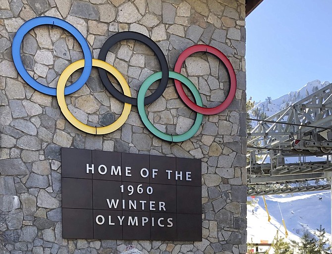 This photo taken Dec. 26, 2018 shows a sign with the Olympic rings at Squaw Valley ski resort where the 1960 Winter Olympics were held near Lake Tahoe. Conservationists have agreed to drop a lawsuit challenging plans to build a 2-mile-long gondola connecting Squaw Valley to neighboring Alpine Meadows ski resort in exchange for neighboring land purchases and other wildlife protection measures. (AP Photo/Scott Sonner).