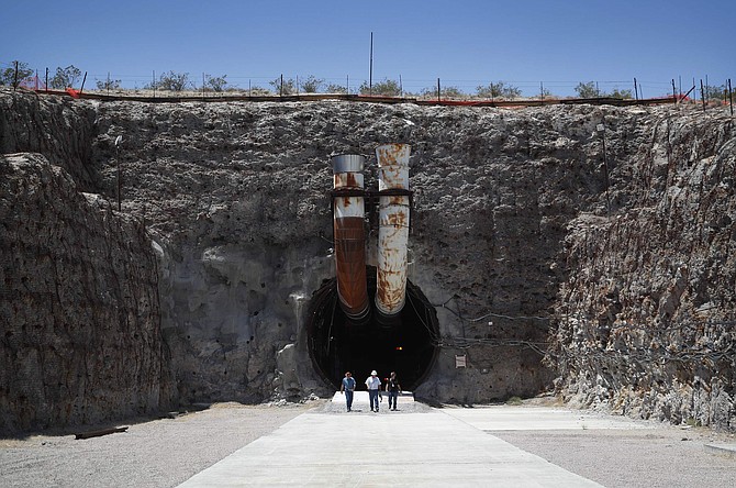 FILE - In this July 14, 2018, file photo, people leave the south portal of Yucca Mountain during a congressional tour near Mercury, Nev. President Donald Trump appears to have reversed position to now oppose creating a national nuclear waste dump at Nevada&#039;s Yucca Mountain. Trump tweeted Thursday, Feb. 6, 2020, that his administration will respect the state, which has argued that the site about 100 miles from Las Vegas isn&#039;t suitable. (AP Photo/John Locher, File)