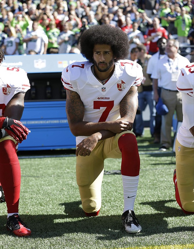 FILE - In this Sept. 25, 2016, file photo, San Francisco 49ers&#039; Colin Kaepernick kneels during the national anthem before an NFL football game against the Seattle Seahawks in Seattle. The same guys who banished Kaepernick from the league for kneeling during the anthem to raise awareness about those very same issues have ruthlessly commandeered his cause. (AP Photo/Ted S. Warren, File)