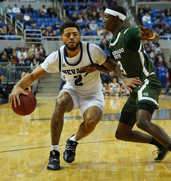 Jalen Harris, shown against Colorado State&#039;s Kendle Moore on Jan. 1, has a chance to set Nevada&#039;s single-season scoring record.