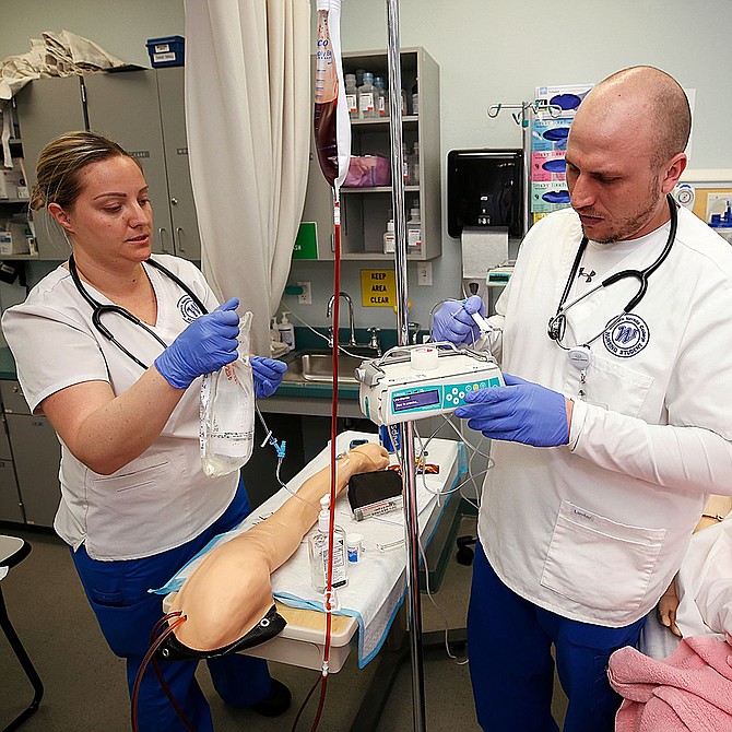 Kattie Pagmossin and Jacob Phillips work in a nursing lab at Western Nevada College in Carson City on April 9.
