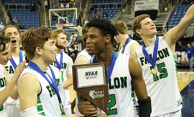 Brock Richardson, left, and Elijah Jackson, along with the Greenwave, celebrate their 3A bfs state basketball championship.