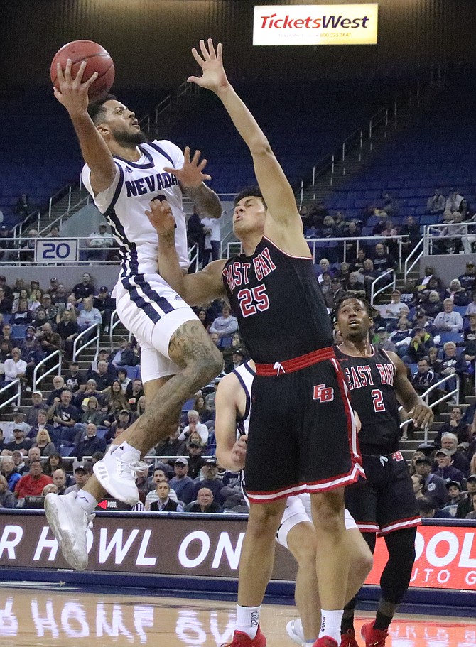 Jalen Harris shoots over Cal-State East Bay&#039;s Justin Vigil in an exhibition game at the beginning of the season.