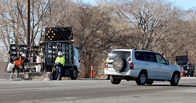 Workers prepare the northwest corner of U.S. Highway 50 and Sheckler Cutoff on Monday for temporary traffic lights.