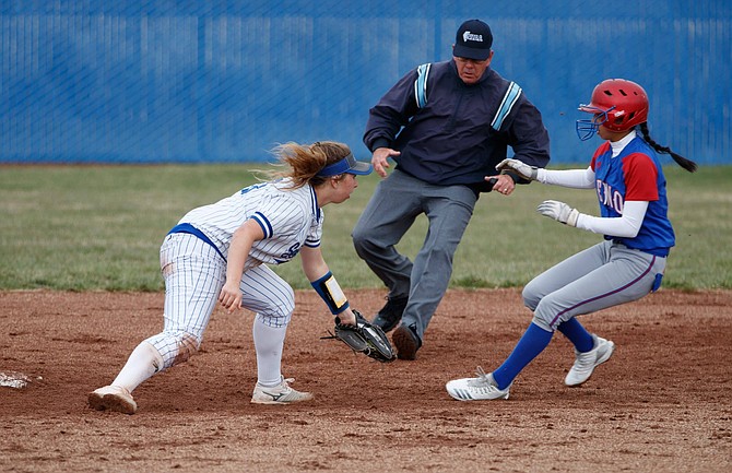 Carson High Shortstop Bella Kordonowy moves to tag a Reno High baserunner during the game between Carson High and Reno High at Carson High. 