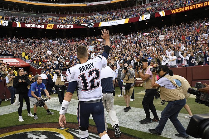 New England Patriots quarterback Tom Brady (12) waves as he walks off the field after an NFL football game against the Washington Redskins, Sunday, Oct. 6, 2019, in Washington. The New England Patriots won 33-7. 