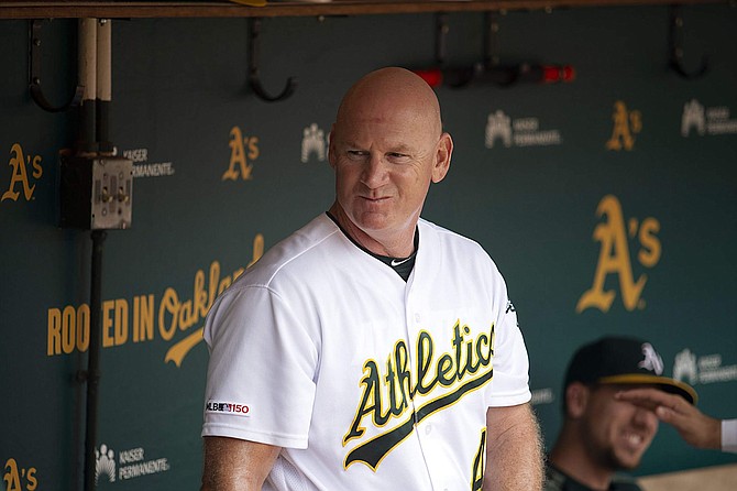 Then-Oakland Athletics third base coach Matt Williams is shown in the dugout before a game on Sept. 22.