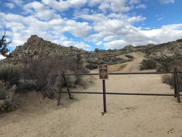 A gate and sign installed by Open Space to keep OHVs out of a portion of Prison Hill.  