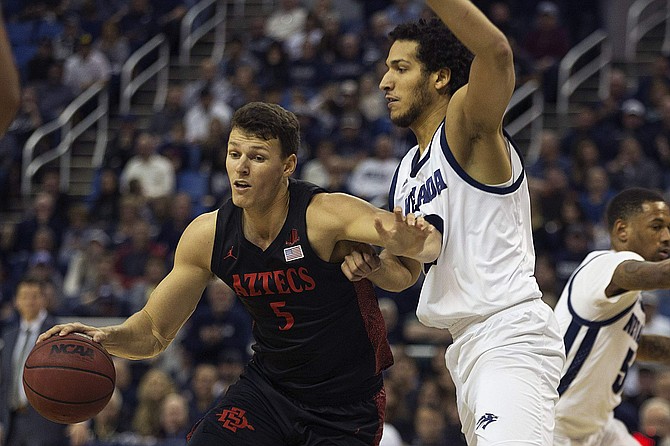 San Diego State forward Yanni Wetzell drives past Nevada forward Johncarlos Reyes during Saturday&#039;s game at Lawlor Events Center in Reno.