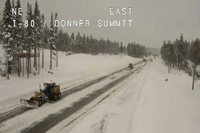 In this still image taken from a Caltrans remote video traffic camera, snowplows work along Interstate 80 at Donner Summit, Calif., Tuesday, March 17, 2020. Another round of snow snarled traffic with more than a dozen crashes on slippery roads in Reno and triggered chain controls on I-80 in the Sierra. Chains were mandatory for a 55-mile (66-kilometer) stretch of I-80 from the California-Nevada line west of Reno over the top of Donner Pass in Placer County California. The only exception is four-wheel vehicles with snow tires. 