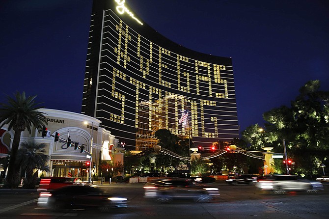 Hotel room lights spell out &quot;Vegas Strong&quot; at the Wynn hotel-casino along the Las Vegas Strip as casinos and other business are shuttered due to the coronavirus outbreak Wednesday, April 1, 2020, in Las Vegas. (AP Photo/John Locher)