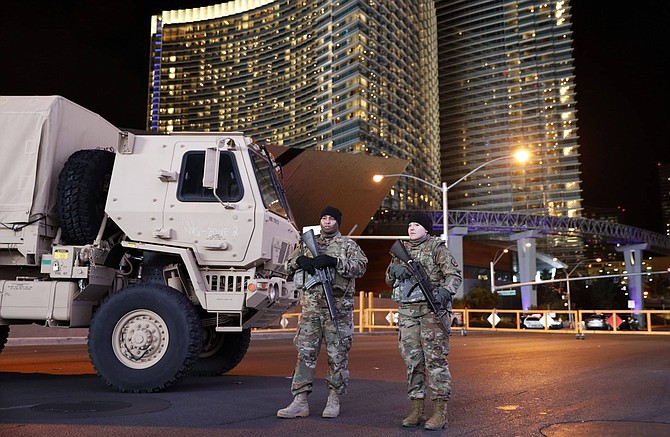 FILE - In this Dec. 31, 2018, file photo, members of the Nevada National Guard stand at a roadblock on a road leading to the Las Vegas Strip during a New Year&#039;s celebration in Las Vegas. State and federal officials are finalizing details of the role Nevada&#039;s National Guard will play in the statewide response to the coronavirus, but they&#039;re emphasizing the mission won&#039;t include enforcing martial law. The governor has activated the National Guard each New Year&#039;s Eve since the 9/11 terrorist attacks to help patrol the Las Vegas Strip. Nevada&#039;s Guard regularly is deployed overseas, but the most recent non-New Year&#039;s activation within the state was March 2017 when 140 troops responded to flooding north of Reno and President Trump approved federal disaster funding, similar to what&#039;s expected to occur now, said 1st Lt. Emerson Marcus, the Nevada Guard&#039;s historian. 