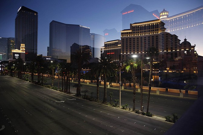 Photographed through glass, streets are empty of traffic along the Las Vegas Strip as casinos and other business are closed due to the coronavirus outbreak, Tuesday, April 14, 2020, in Las Vegas. 
