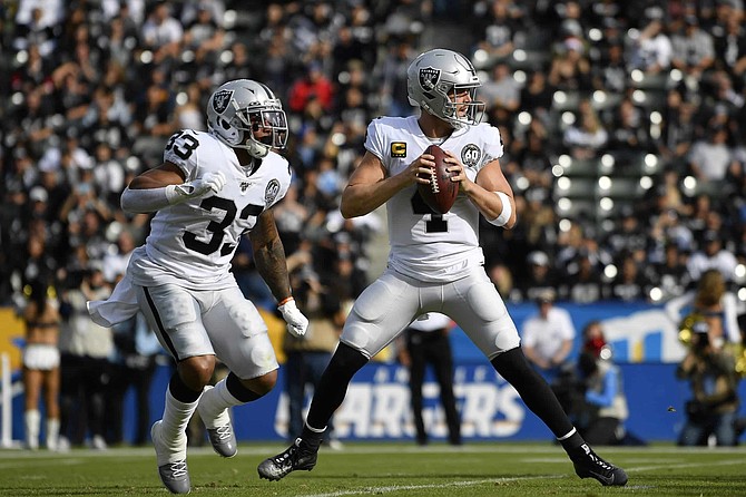 Oakland Raiders quarterback Derek Carr in action during the first half of an NFL football game against the Los Angeles Chargers in Carson, Calif., Sunday, Dec. 22, 2019. 