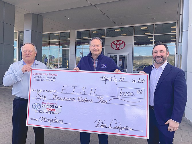 Carson City Toyota&#039;s Dana Whaley (left) and Jeff Campagni (right) present a check to Jim Peckham, FISH executive director.