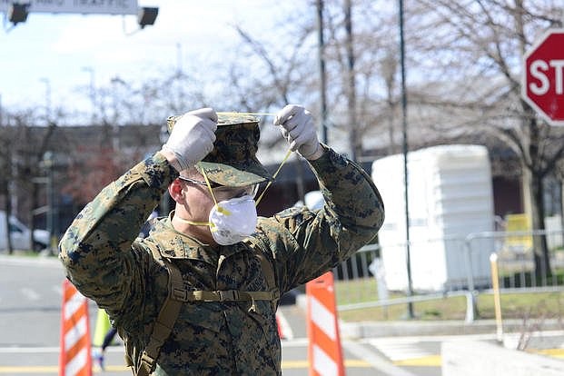 Service members and civilians are required to wear face coverings effective Monday at all Department of Defense installations.