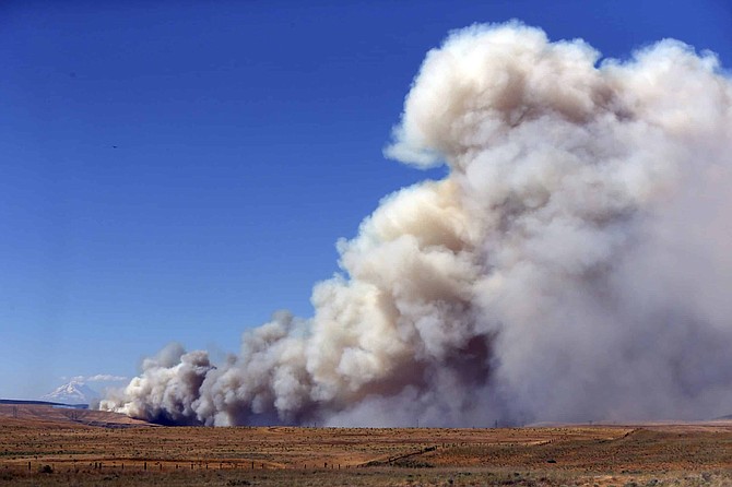 FILE - In this Wednesday, July 18, 2018 file photo, a fast-moving fire continues to burn across Wasco County southeast of The Dalles, Ore., with drought conditions in many areas of the region.  two-decade-long dry spell that has parched much of the western United States is turning into one of the deepest megadroughts in the region in more than 1,200 years, and about half of this historic drought can be blamed on man-made global warming, according to a study released Thursday, April 16, 2020 in the journal Science. (Mark Graves/The Oregonian via AP)