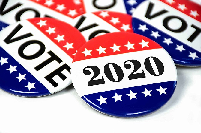 close up of political voting pins for 2020 election on white