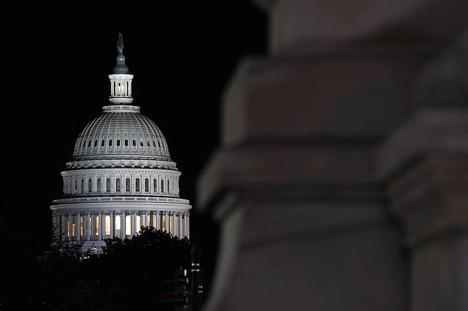 Floodlights illuminate the U.S. Capitol dome in Washington, late Tuesday, Nov. 12, 2019. The public impeachment inquiry hearings set to begin Wednesday will pit a Democratic attorney who built his reputation as a federal mob and securities fraud prosecutor against a GOP House Oversight investigator who helped steer some of the most notable probes of the Obama administration. (AP Photo/Patrick Semansky)