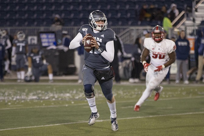 Nevada quarterback Carson Strong (12 ) rolls out against New Mexico second half of an NCAA college football game in Reno, Nev., Saturday, Nov. 2, 2019. 