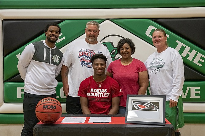 Fallon&#039;s Elijah Jackson, who signed with
Southern Oregon University on Saturday, is joined by, from left, assistant
coach Brandon Sanders, his parents, Jesse Schulenberg and Roxanne
Walker-Schulenberg, and head coach Chelle Dalager.