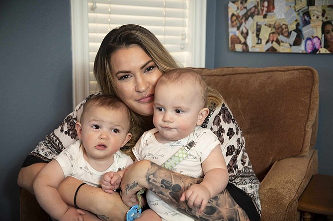 Breann McCulloch, who&#039;s struggled with addiction, and her 9-month-old twin boys Valor and Rebel pose for a portrait in their home, Wednesday, May 13, 2020. Isolation due to quarantine can be damaging for those grappling with addiction, who say that social interaction and staying busy are the only things helping them stay clean. 