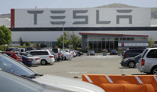 Vehicles are seen parked at the Tesla plant Monday, May 11, 2020, in Fremont, Calif. The parking lot was nearly full at Tesla&#039;s California electric car factory Monday, an indication that the company could be resuming production in defiance of an order from county health authorities. 