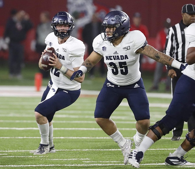 Nevada quarterback Carson Strong drops back to pass against Fresno State during the second half of an NCAA college football game in Fresno, Calif., Saturday, Nov. 23, 2019. 