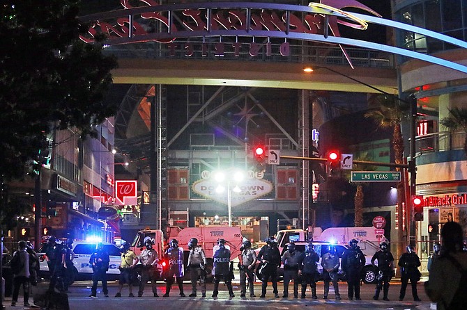 Police stand in formation at the entrance to Fremont Street Experience Monday, June 1, 2020, in downtown Las Vegas. Police were present for a community protest over the death of George Floyd, a Minneapolis man who died in police custody on Memorial Day. 